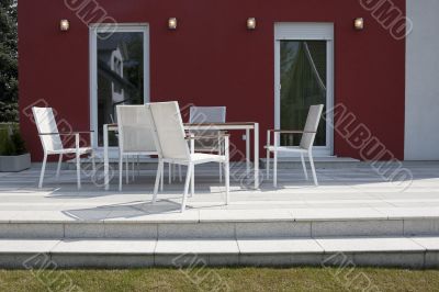 Garden armchair in front of house