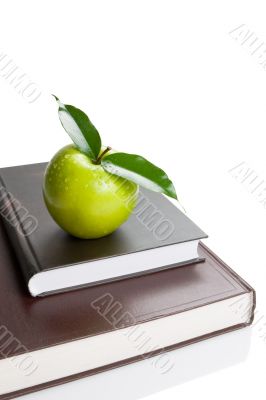 Books and green apple