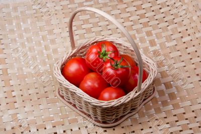 Tomato basket with bamboo mat background