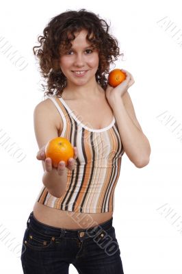 Smiling young healthy woman is holding the orange.