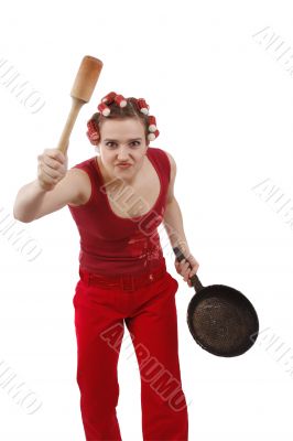 Angry woman in hair rollers, holding a frying pan.