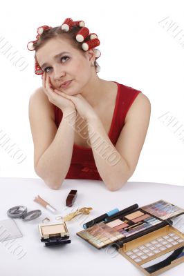 Woman with hair-rollers thinks about something.
