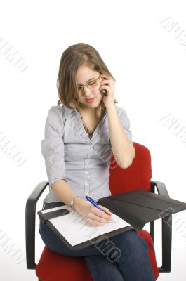 businesswoman talking into a mobile phone on white