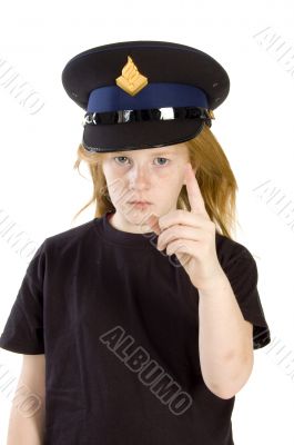 young girl with police hat is giving a warning sign