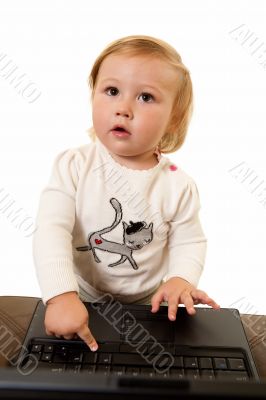 Adorable baby with laptop