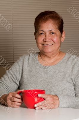Woman having a cup of coffee at home