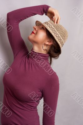 girl in bright hat standing half-face