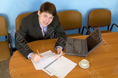 Businessman on a workplace with the laptop