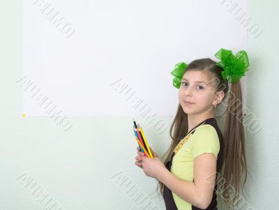 Girl with color pencils and a sheet of paper