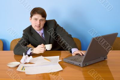 Businessman on a workplace with the laptop