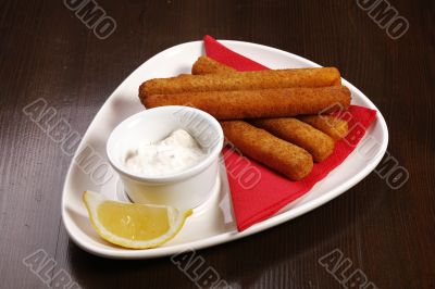 roasted cheese sticks on white plate