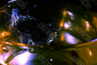 splash on clear glass with colored light