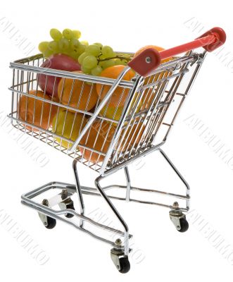 Shopping trolley with fruits, supermarket