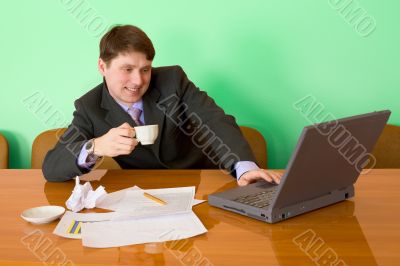 Businessman on a workplace with the laptop