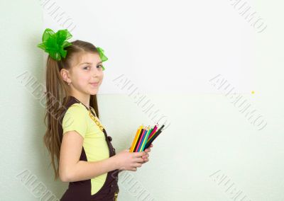 Girl with color pencils and a sheet of paper