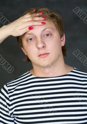 Man with female hand on his forehead