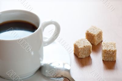 Cup of coffee and reed sugar