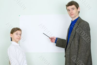 Teacher explains something to the schoolgirl