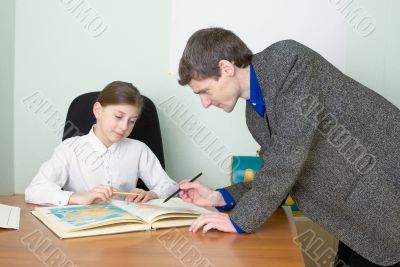 Tutor and schoolgirl with atlas