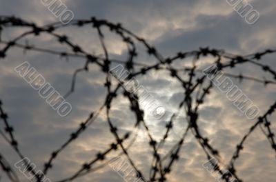 The sun behind a fencing