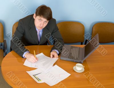 Businessman on a workplace with the laptop