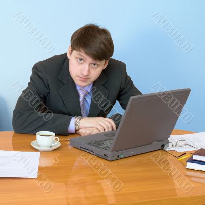 Businessman on a workplace with the laptop