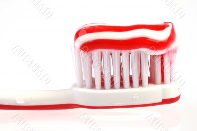 red toothbrush with toothpaste