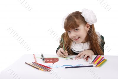 Girl is drawing  in pencil.