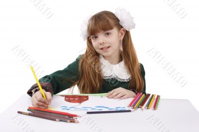 Girl is drawing  in pencil.