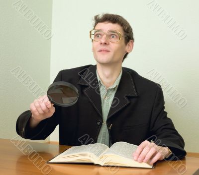 Guy in eyeglasses reads the book