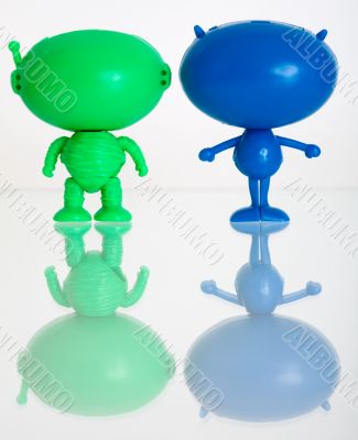 Two figures of aliens on a white