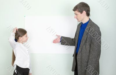 Teacher explains something to the schoolgirl