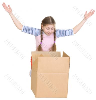 Little girl joyfully looks in a box