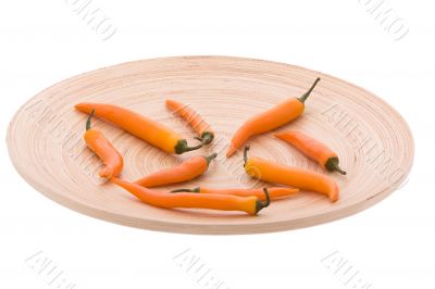 Orange chilli in the wood plate