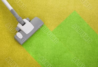vacuum cleaner on a green carpet