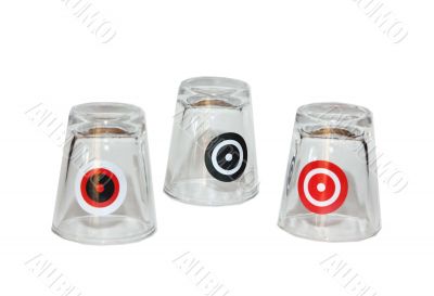 Three shot glasses with targets on them