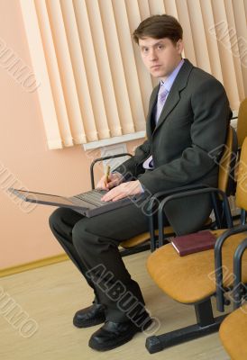 Person in a suit with the laptop