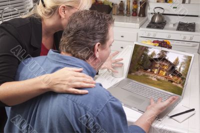 Couple In Kitchen Using Laptop - Cabin