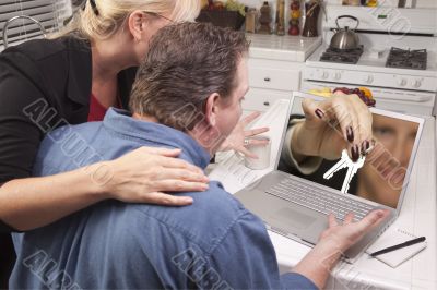 Couple In Kitchen Using Laptop - House Keys