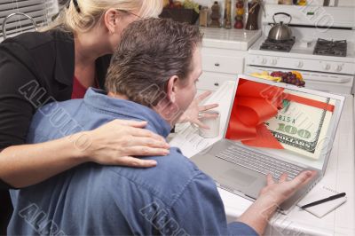 Couple In Kitchen Using Laptop - Money