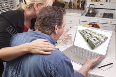 Couple In Kitchen Using Laptop - Money