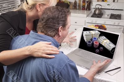 Couple In Kitchen Using Laptop - Online Poker