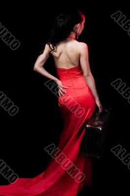 lady in red with suitcase