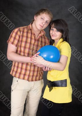 Pair holds on hands a ballon as the baby