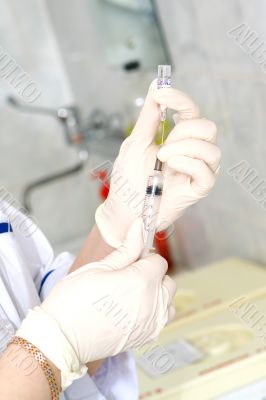 Hands with syringe and ampoule