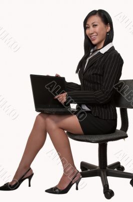 Woman sitting and working on laptop