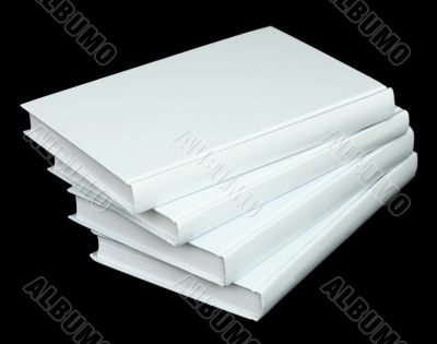 Pile from four book volumes on a black