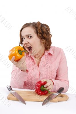 Girl is eating the pepper.