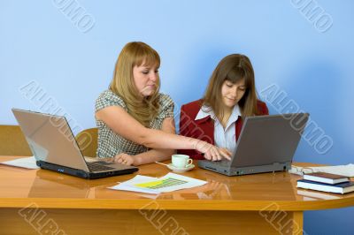Girls work sitting at a table