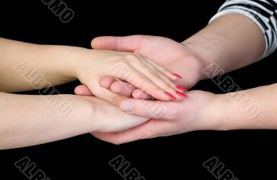 Man`s and female hands on a black